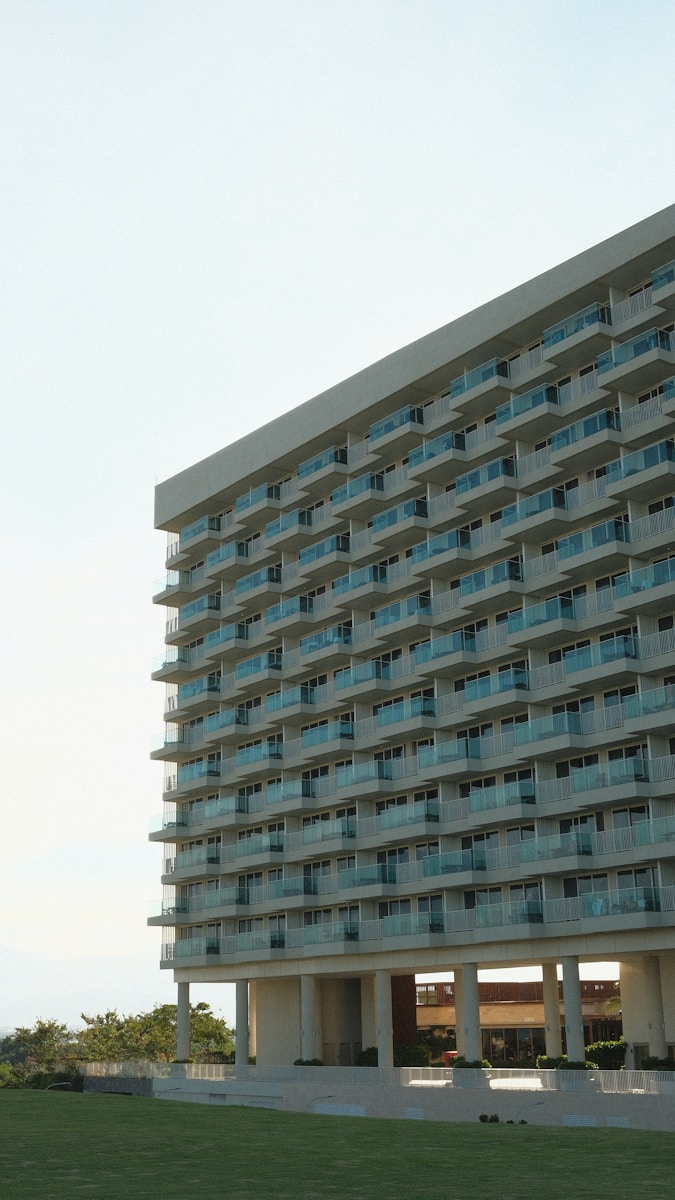 a tall building with balconies on top of it fully occupied by tenants with renters insurance